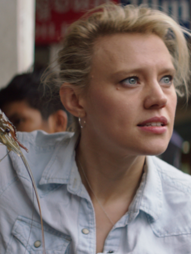 Breakfast, Lunch, & Dinner - Season 1..Kate McKinnon handles a live prawn from a street vendor in Phnom Penh